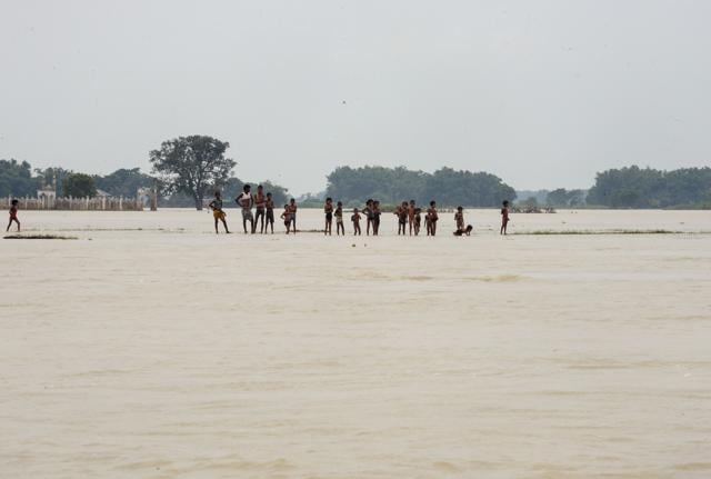 Youngsters stand on a narrow strip of land surrounded by floodwaters in Purnia district of Bihar state on August 18, 2017. (AFP) Youngsters stand on a narrow strip of land surrounded by floodwaters in Purnia district of Bihar state on August 18, 2017. (AFP)