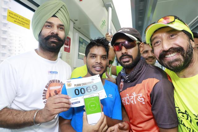 Abhishek Mishra (in orange) poses with the winner of the challenge, Pramod Bisht, who held the plank position for over 30 minutes. Abhishek Mishra (in orange) poses with the winner of the challenge, Pramod Bisht, who held the plank position for over 30 minutes.