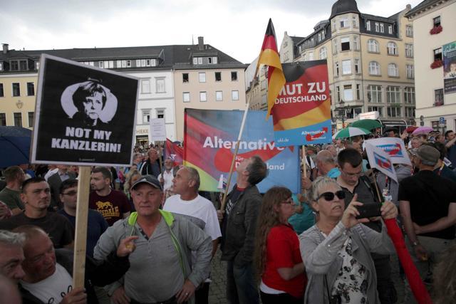 Alternative for Germany party supporters protest during the election rally of the German Chancellor Angela Merkel, a top candidate of the Christian Democratic Union Party (CDU), in Annaberg-Buchholz, Germany August 17, 2017, ahead of the upcoming federal election. Sign (R) reads "Courage for Germany", sign (L) reads "Not My Chancellor". (REUTERS) Alternative for Germany party supporters protest during the election rally of the German Chancellor Angela Merkel, a top candidate of the Christian Democratic Union Party (CDU), in Annaberg-Buchholz, Germany August 17, 2017, ahead of the upcoming federal election. Sign (R) reads "Courage for Germany", sign (L) reads "Not My Chancellor". (REUTERS)