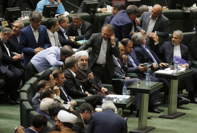 Iranian President Hassan Rouhani talks to parliament members after addressing the parliament in the capital Tehran on August 15, 2017. (AFP) Iranian President Hassan Rouhani talks to parliament members after addressing the parliament in the capital Tehran on August 15, 2017. (AFP)