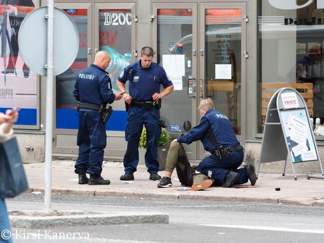 The suspect lies on the ground surrounded by police officers at the Market Square where several people were stabbed, in Turku, Finland August 18, 2017. (REUTERS) The suspect lies on the ground surrounded by police officers at the Market Square where several people were stabbed, in Turku, Finland August 18, 2017. (REUTERS)