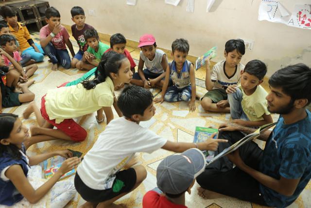 Children during a read aloud session with Sumit Parewa, at The Community Libray Project , Sikanderpur, Gurgaon. (Manoj Verma/HT Photo)
