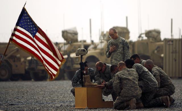 US army officers with the 101st Airborne Division pay their respects by the boots, gun, helmet and dog-tags of US army First Lieutenant Todd W Weaver displayed during a memorial ceremony in his honour at Combat Outpost Terra Nova on the outskirts the Arghandab Valley's Jellawar village on September 14, 2010. (AFP) US army officers with the 101st Airborne Division pay their respects by the boots, gun, helmet and dog-tags of US army First Lieutenant Todd W Weaver displayed during a memorial ceremony in his honour at Combat Outpost Terra Nova on the outskirts the Arghandab Valley's Jellawar village on September 14, 2010. (AFP)