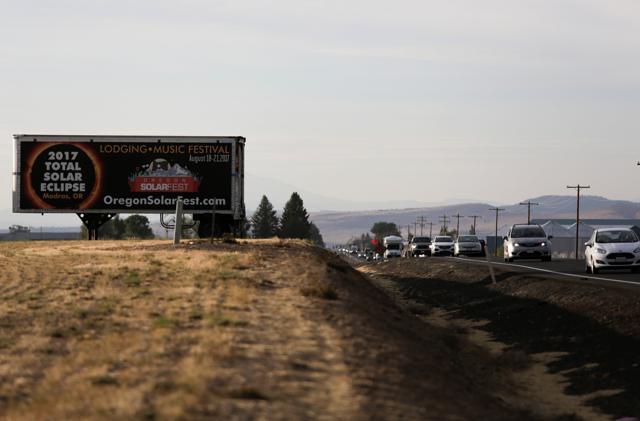 A sign promoting the solar eclipse is pictured as people drive into Madras, Oregon, US. (Reuters) A sign promoting the solar eclipse is pictured as people drive into Madras, Oregon, US. (Reuters)