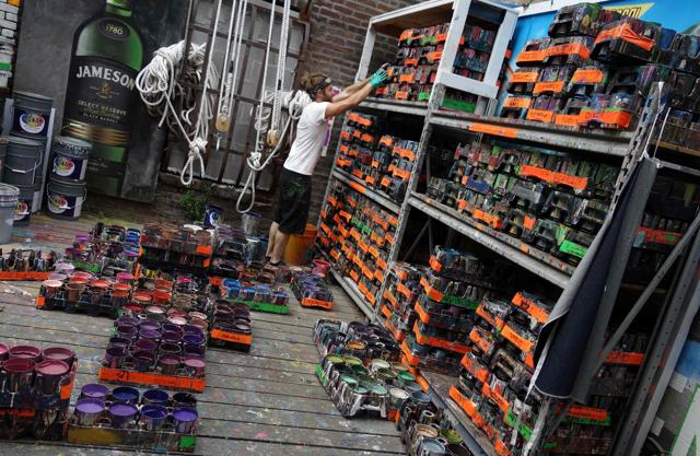 Will Krieg, an apprentice for Colossal Media, organises paints at Colossal Media's office building. (AFP) Will Krieg, an apprentice for Colossal Media, organises paints at Colossal Media's office building. (AFP)