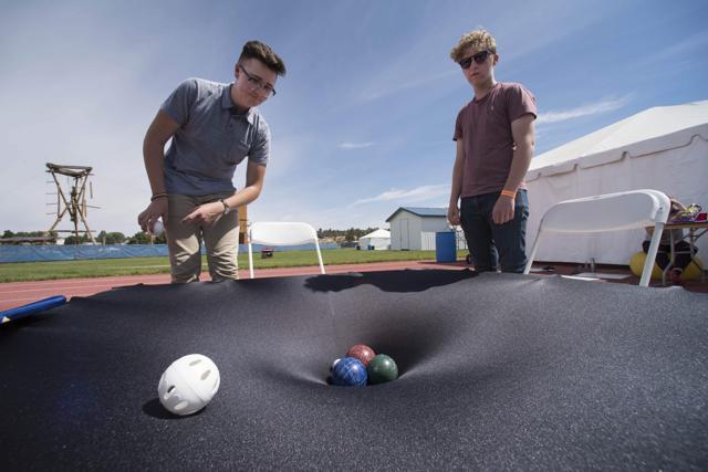 James Linkey (left) and Aiden Cody (right) of the Flagstaff Arts and Leadership Academy demonstrate how gravity works at the Lowell Observatory Solar Eclipse Experience August 20, 2017 in Madras, Oregon. (AFP Photo) James Linkey (left) and Aiden Cody (right) of the Flagstaff Arts and Leadership Academy demonstrate how gravity works at the Lowell Observatory Solar Eclipse Experience August 20, 2017 in Madras, Oregon. (AFP Photo)