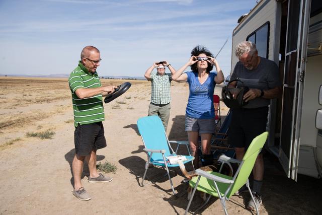 Martin Ferreira (left) Brian Callagan (back left) Michele Nemschoff (middle) and Keith Petterson (right), total eclipse enthusiasts, try out their protective eye wear, including a non-certified welder's shield, waiting out standstill traffic on the side of a rural farm road near Madras, Oregon. (AFP Photo) Martin Ferreira (left) Brian Callagan (back left) Michele Nemschoff (middle) and Keith Petterson (right), total eclipse enthusiasts, try out their protective eye wear, including a non-certified welder's shield, waiting out standstill traffic on the side of a rural farm road near Madras, Oregon. (AFP Photo)