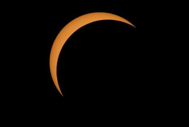 The moon is seen passing in front of the sun during a solar eclipse from Ross Lake, Northern Cascades National Park, in Washington. (AP)