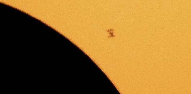 The International Space Station is silhouetted against the sun during the partial solar eclipse (AP Photo)