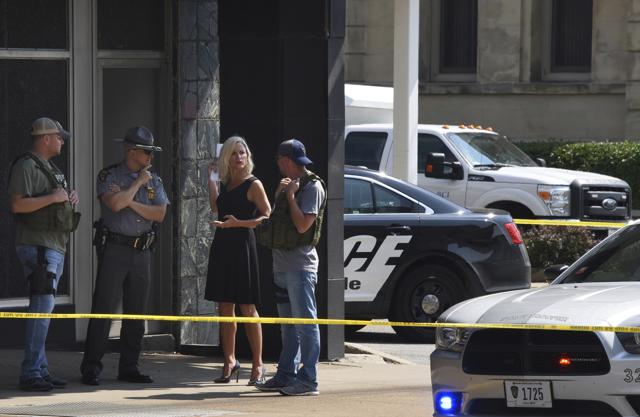 Officials consult near the crime scene at the Huntington Bank, next to the Courthouse in Steubenville, Ohio after Jefferson County Judge Joseph Bruzzese Jr was ambushed. (AP) Officials consult near the crime scene at the Huntington Bank, next to the Courthouse in Steubenville, Ohio after Jefferson County Judge Joseph Bruzzese Jr was ambushed. (AP)