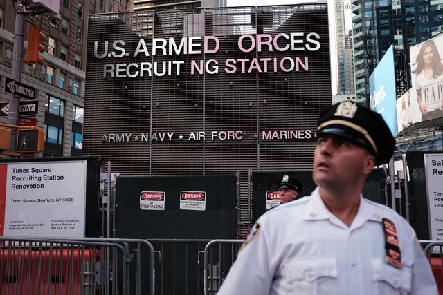This file photo taken on July 25, 2017 shows a police officer standing guard as dozens of protesters gather in Times Square near a military recruitment center to show their anger at President Donald Trump's decision to reinstate a ban on transgender individuals from serving in the military in New York City. (AFP) This file photo taken on July 25, 2017 shows a police officer standing guard as dozens of protesters gather in Times Square near a military recruitment center to show their anger at President Donald Trump's decision to reinstate a ban on transgender individuals from serving in the military in New York City. (AFP)