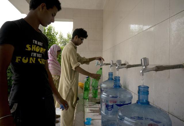 People at a filtration plant fill their bottles with water from a tube well in Islamabad. (AP Photo) People at a filtration plant fill their bottles with water from a tube well in Islamabad. (AP Photo)