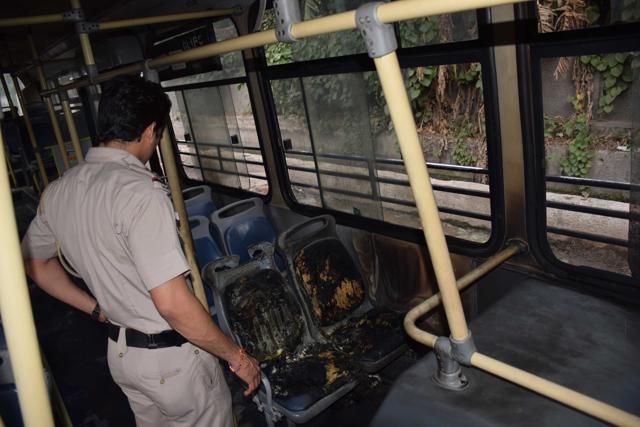 A policeman inside a bus which was burnt near Jahangirpuri on Friday after Dera Sacha Sauda Gurmeet Ram Rahim Singh was convicted in a rape case. (HT Photo) A policeman inside a bus which was burnt near Jahangirpuri on Friday after Dera Sacha Sauda Gurmeet Ram Rahim Singh was convicted in a rape case. (HT Photo)