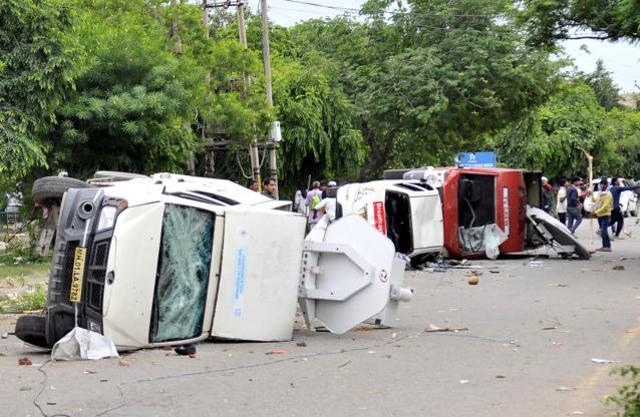 Damaged media vehicles in Sector 4 of Panchkula. (Ravi Kumar/HT)