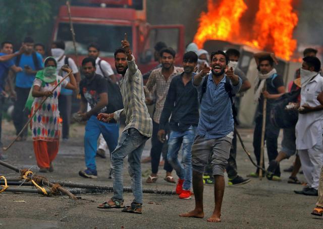 People reacting during violence in Panchkula. (REUTERS) People reacting during violence in Panchkula. (REUTERS)