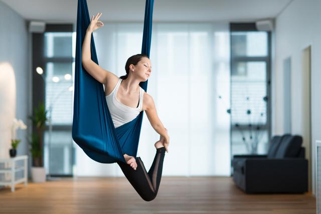 Aerial yoga is practiced with the help of a cloth hammock suspended from a ceiling. (Shutterstock) Aerial yoga is practiced with the help of a cloth hammock suspended from a ceiling. (Shutterstock)