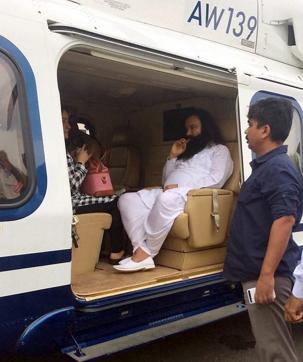 Dera Sacha Sauda chief Gurmeet Ram Rahim in a helicopter in which he was flown from Panchkula to Rohtak town to lodged in jail on Friday. (PTI)