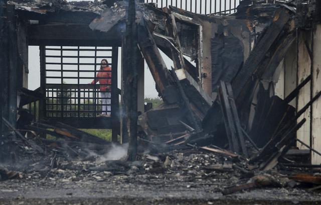 A home owner of a Bolivar, Texas, beach cabin looks over the remains of their home Saturday, Aug. 26, 2017, after a fire destroyed it and two others during Hurricane Harvey's early morning land fall. (AP) A home owner of a Bolivar, Texas, beach cabin looks over the remains of their home Saturday, Aug. 26, 2017, after a fire destroyed it and two others during Hurricane Harvey's early morning land fall. (AP)