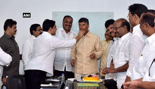 Andhra chief minister Chandrababu Naidu and minister Nara Lokesh celebrate TDP victory. (ANI) Andhra chief minister Chandrababu Naidu and minister Nara Lokesh celebrate TDP victory. (ANI)