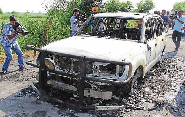 A car torched by unidentified people at Kotli village in Sirsa on Monday. (PTI) A car torched by unidentified people at Kotli village in Sirsa on Monday. (PTI)