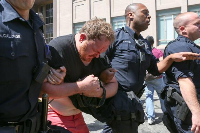 A bloodied man is escorted out by police after a clash with the police on August 27, 2017 at Martin Luther King Park Jr. Civic Center Park in Berkeley, California. (AFP Photo) A bloodied man is escorted out by police after a clash with the police on August 27, 2017 at Martin Luther King Park Jr. Civic Center Park in Berkeley, California. (AFP Photo)