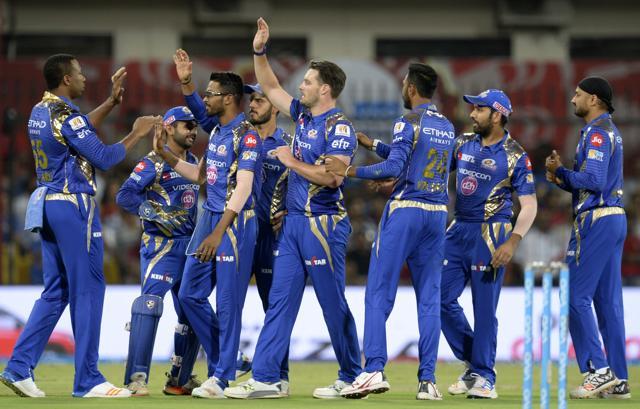 Mumbai Indians players including Mitchell McClenaghan (C) congratulate teammate Kieron Pollard (L) as they celebrate the wicket of Kings XI Punjab cricketer Shaun Marsh during the 2017 Indian Premier League (IPL) Twenty20 cricket match at the Holkar Cricket Stadium in Indore on April 20, 2017. (AFP)