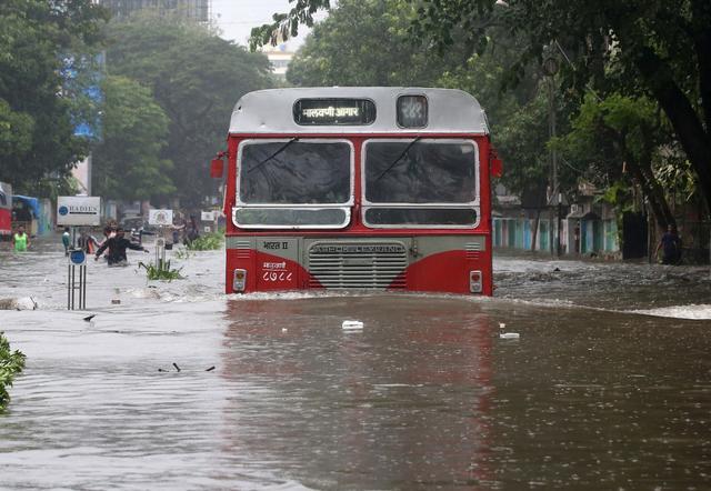A bus moves through a water-logged road in Mumbai on Tuesday. (REUTERS)