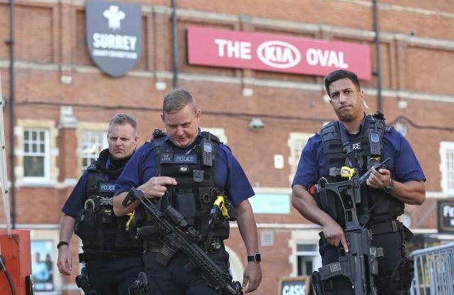 Police secure the area outside The Oval cricket ground in London, after play was suspended in the County Championship clash between Surrey and Middlesex after an arrow was fired onto the pitch, Thursday. (AP)