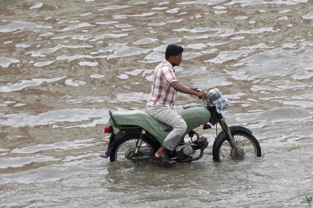 A man rides a motorcycle along a flooded street after heavy rains in Karachi on August 31, 2017. (Reuters)
