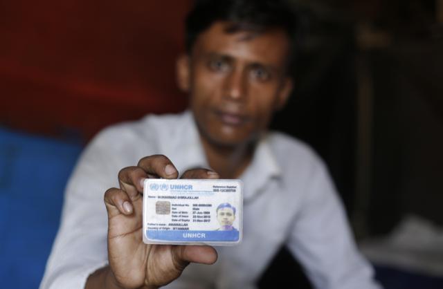 A Rohingya refugee Mohammad Sirajullah displays his UNHCR card as he sits inside his shanty at a temporary shelter in New Delhi, India, Wednesday, Aug. 16, 2017. (AP) A Rohingya refugee Mohammad Sirajullah displays his UNHCR card as he sits inside his shanty at a temporary shelter in New Delhi, India, Wednesday, Aug. 16, 2017. (AP)