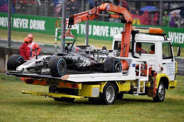 Romain Grosjean’s car is lifted off the circuit following a crash during rain in the qualifying session. (AFP)