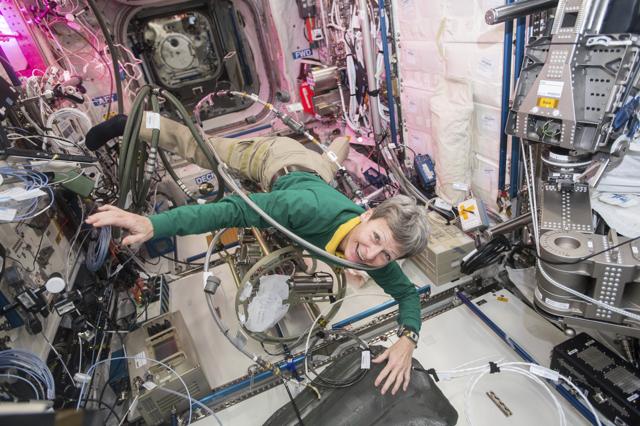 In this December 8, 2016 photo made available by NASA, astronaut Peggy Whitson floats through a tangle of cables inside the Columbus module aboard the International Space Station. Whitson was operating the Fluids System Servicer to refill coolant loops in multiple modules on the US segment of the station. (AP)