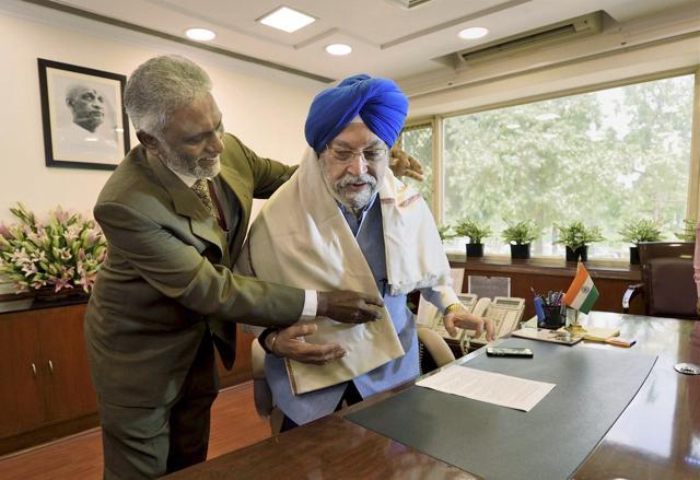 Hardeep Singh Puri, Minister of State for Housing & Urban Affairs (Independent Charge) being felicitated by Medithi Ravi Kanth, CMD HUDCO while he takes charge at his office in New Delhi on Monday. (PTI) Hardeep Singh Puri, Minister of State for Housing & Urban Affairs (Independent Charge) being felicitated by Medithi Ravi Kanth, CMD HUDCO while he takes charge at his office in New Delhi on Monday. (PTI)