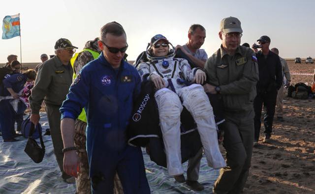 Ground personnel carry US astronaut Peggy Annette Whitson after landing in a remote area outside the town of Dzhezkazgan, Kazakhstan. (AP Photo) Ground personnel carry US astronaut Peggy Annette Whitson after landing in a remote area outside the town of Dzhezkazgan, Kazakhstan. (AP Photo)
