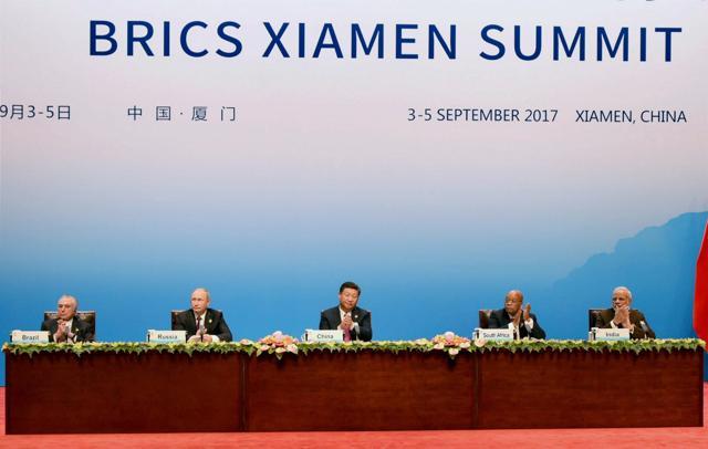 Chinese President Xi Jinping (C) delivers his speech while flanked by Brazilian President Michel Temer (L), Russian President Vladimir Putin (2nd L), South Africa's President Jacob Zuma (2nd R), and Indian Prime Minister Narendra Modi (R) during the BRICS Business Council signing ceremony. (PTI) Chinese President Xi Jinping (C) delivers his speech while flanked by Brazilian President Michel Temer (L), Russian President Vladimir Putin (2nd L), South Africa's President Jacob Zuma (2nd R), and Indian Prime Minister Narendra Modi (R) during the BRICS Business Council signing ceremony. (PTI)