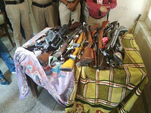 Experts have spotted a semi-automatic shotgun, M1 carbine and M1 Garand rifle among the weapons (in photo) recovered by police. (HT Photo)