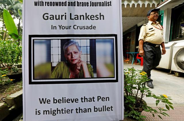 A security guard walks past a placard installed at the Press Club of Kolkata in solidarity with Gauri Lankesh. (REUTERS) A security guard walks past a placard installed at the Press Club of Kolkata in solidarity with Gauri Lankesh. (REUTERS)