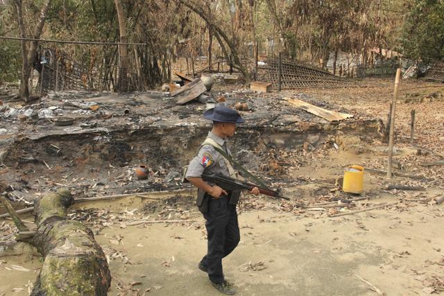 A Myanmar security officer walks past burned Rohingya houses in Ka Nyin Tan village of suburb Maungdaw, northern Rakhine state of western Myanmar, on September 6, 2017. (AP) A Myanmar security officer walks past burned Rohingya houses in Ka Nyin Tan village of suburb Maungdaw, northern Rakhine state of western Myanmar, on September 6, 2017. (AP)