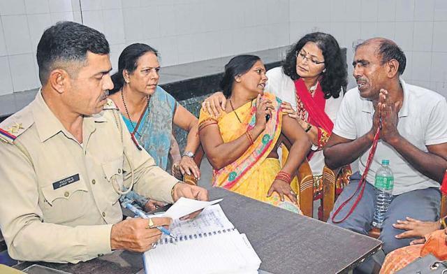 Pushpanjali Chaudhary’s parents with the police. Her father, BL Chaudhary, is a retired driver from the Army. (HT Photo) Pushpanjali Chaudhary’s parents with the police. Her father, BL Chaudhary, is a retired driver from the Army. (HT Photo)
