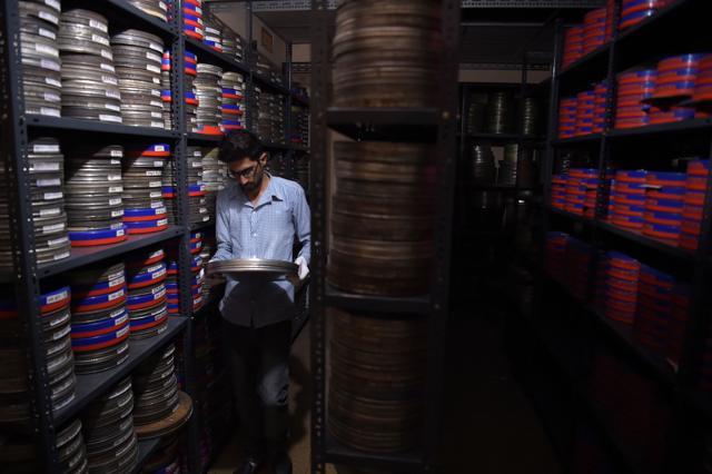 An employee takes a film reel to get it digitised at the state-run Afghan Film department in Kabul. (AFP) An employee takes a film reel to get it digitised at the state-run Afghan Film department in Kabul. (AFP)