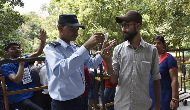 A security guard checks IDs during JNU student union election. (Vipin Kumar /HT PHOTO) A security guard checks IDs during JNU student union election. (Vipin Kumar /HT PHOTO)