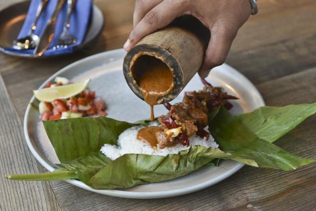 The Oriya deomali mutton is pulled out of a smoked, hollowed-out piece of bamboo and arranged on a bed of jasmine rice, the curry from the bamboo then poured over it. The presentation was memorable; sadly, the flavours were not. (Aalok Soni / HT Photo) The Oriya deomali mutton is pulled out of a smoked, hollowed-out piece of bamboo and arranged on a bed of jasmine rice, the curry from the bamboo then poured over it. The presentation was memorable; sadly, the flavours were not. (Aalok Soni / HT Photo)