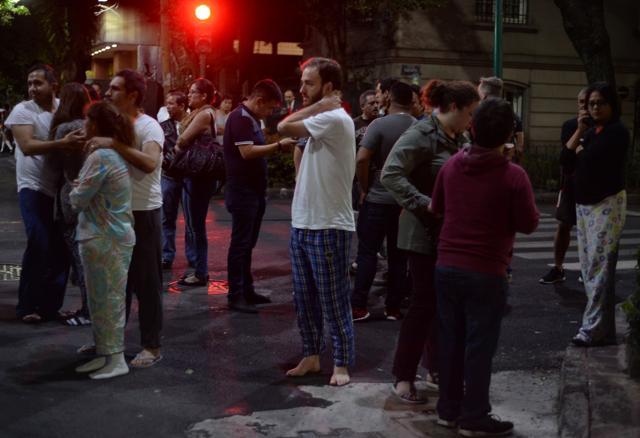People gather on a street in downtown Mexico City during an earthquake on September 7. (AFP Photo) People gather on a street in downtown Mexico City during an earthquake on September 7. (AFP Photo)