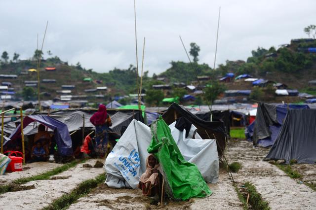 A Rohingya refugee woman sits next to a newly built makeshift shelter in a camp in the Bangladeshi locality of Ukhia on September 9, 2017. (AFP Photo)