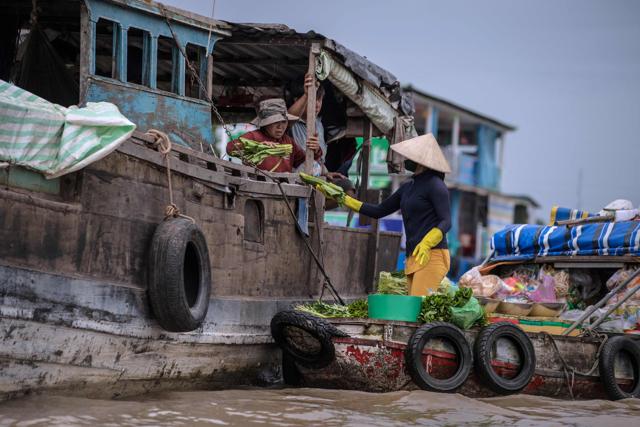 A vendor sells vegetables to a house boat owner in a canal off the Song Hau river at the floating Cai Rang market in Can Tho. (AFP) A vendor sells vegetables to a house boat owner in a canal off the Song Hau river at the floating Cai Rang market in Can Tho. (AFP)
