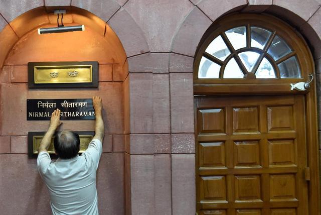 An official installing the nameplate of new defence minister Nirmala Sitharaman outside her office at South Block. (PTI Photo) An official installing the nameplate of new defence minister Nirmala Sitharaman outside her office at South Block. (PTI Photo)