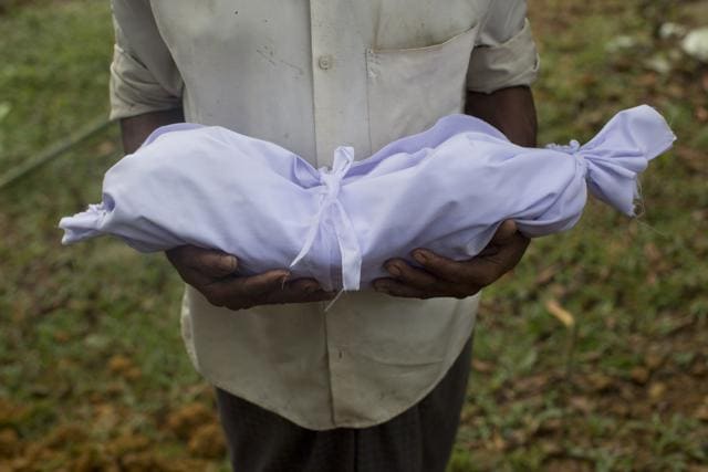 A Rohingya man holds the body of a two-day-old baby before his burial at Kutupalong's refugee camp cemetery, Bangladesh. (AP Photo) A Rohingya man holds the body of a two-day-old baby before his burial at Kutupalong's refugee camp cemetery, Bangladesh. (AP Photo)