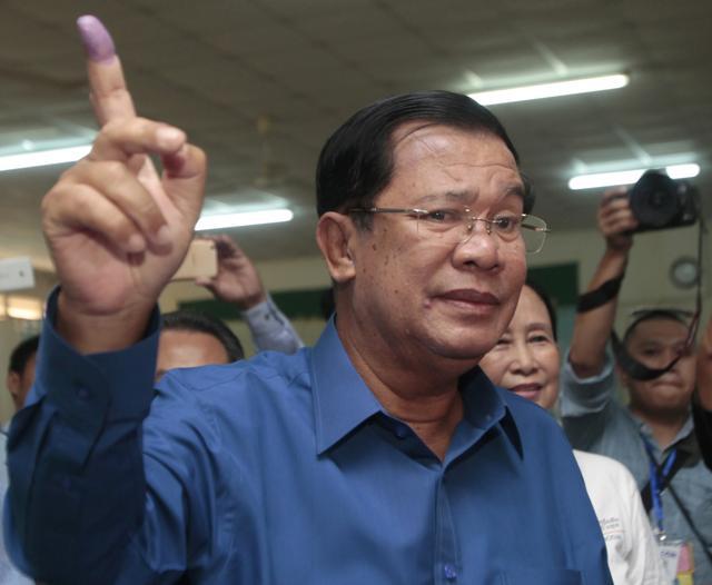 In this June 4, 2017 photo, Cambodian Prime Minister Hun Sen shows off his inked finger after voting in local elections at Takhmau polling station in Kandal province, southeast of Phnom Penh, Cambodia. (AP File Photo) In this June 4, 2017 photo, Cambodian Prime Minister Hun Sen shows off his inked finger after voting in local elections at Takhmau polling station in Kandal province, southeast of Phnom Penh, Cambodia. (AP File Photo)