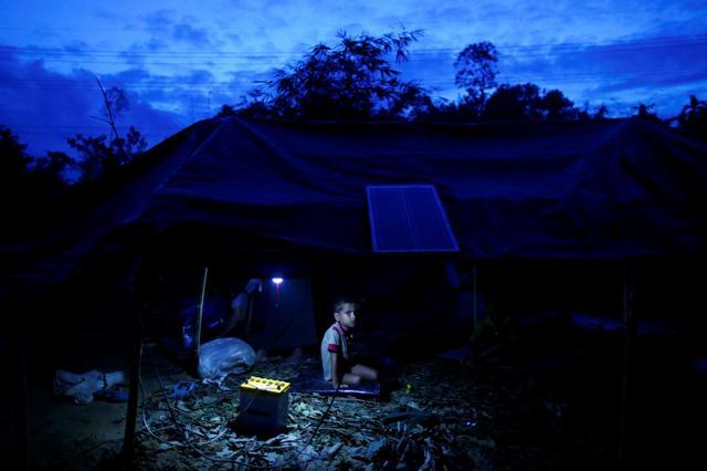A Rohingya refugee boy sits inside his temporary shelter near Balukhali in Cox's Bazar, Bangladesh. (Reuters Photo) A Rohingya refugee boy sits inside his temporary shelter near Balukhali in Cox's Bazar, Bangladesh. (Reuters Photo)