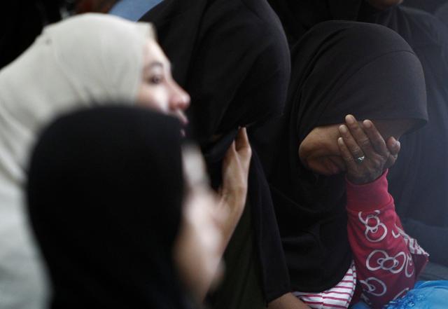 Family members wait for news of their loved ones outside religious school Darul Quran Ittifaqiyah after a fire broke out. (Reuters Photo)